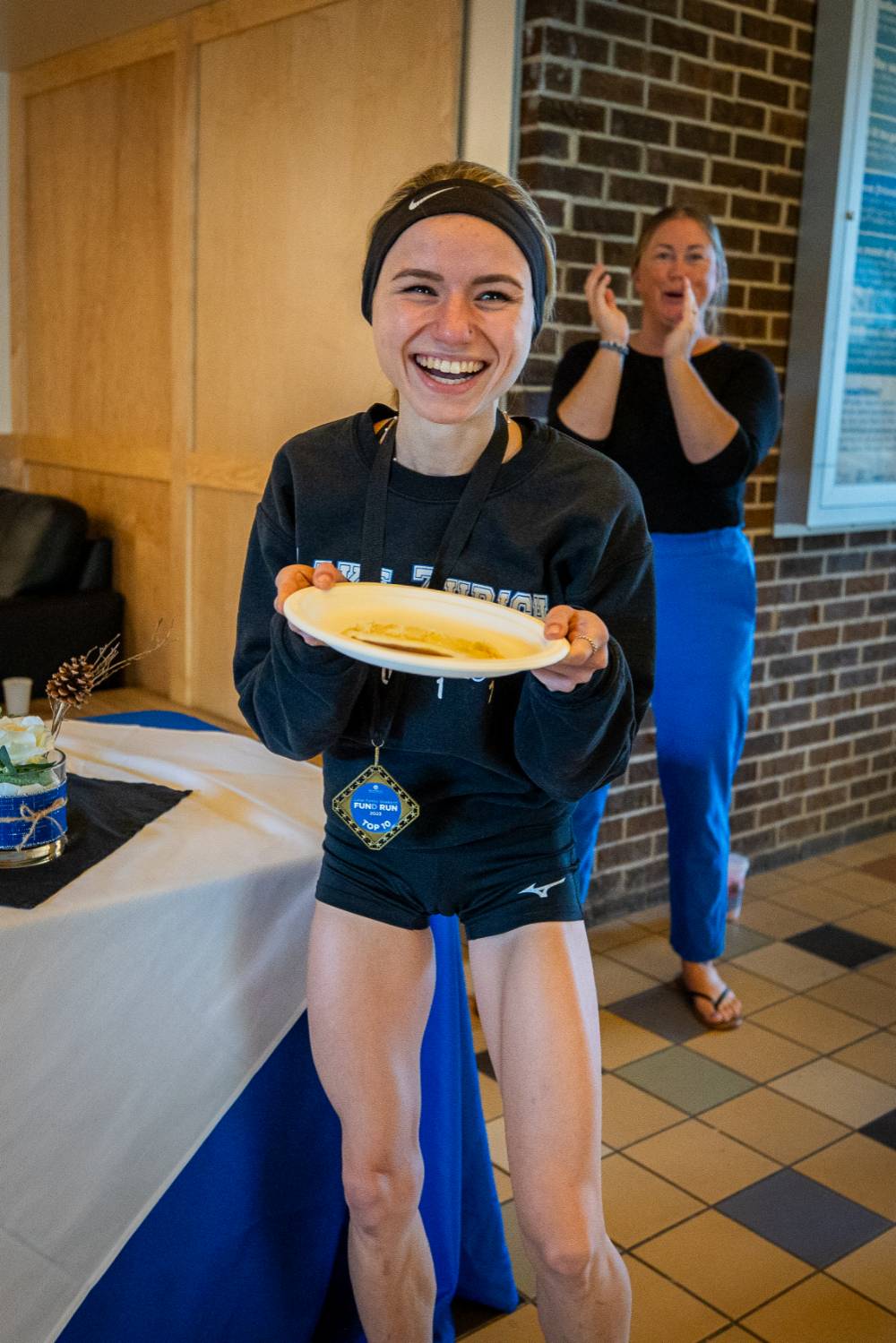 Student showing off pancake during pancake breakfast.